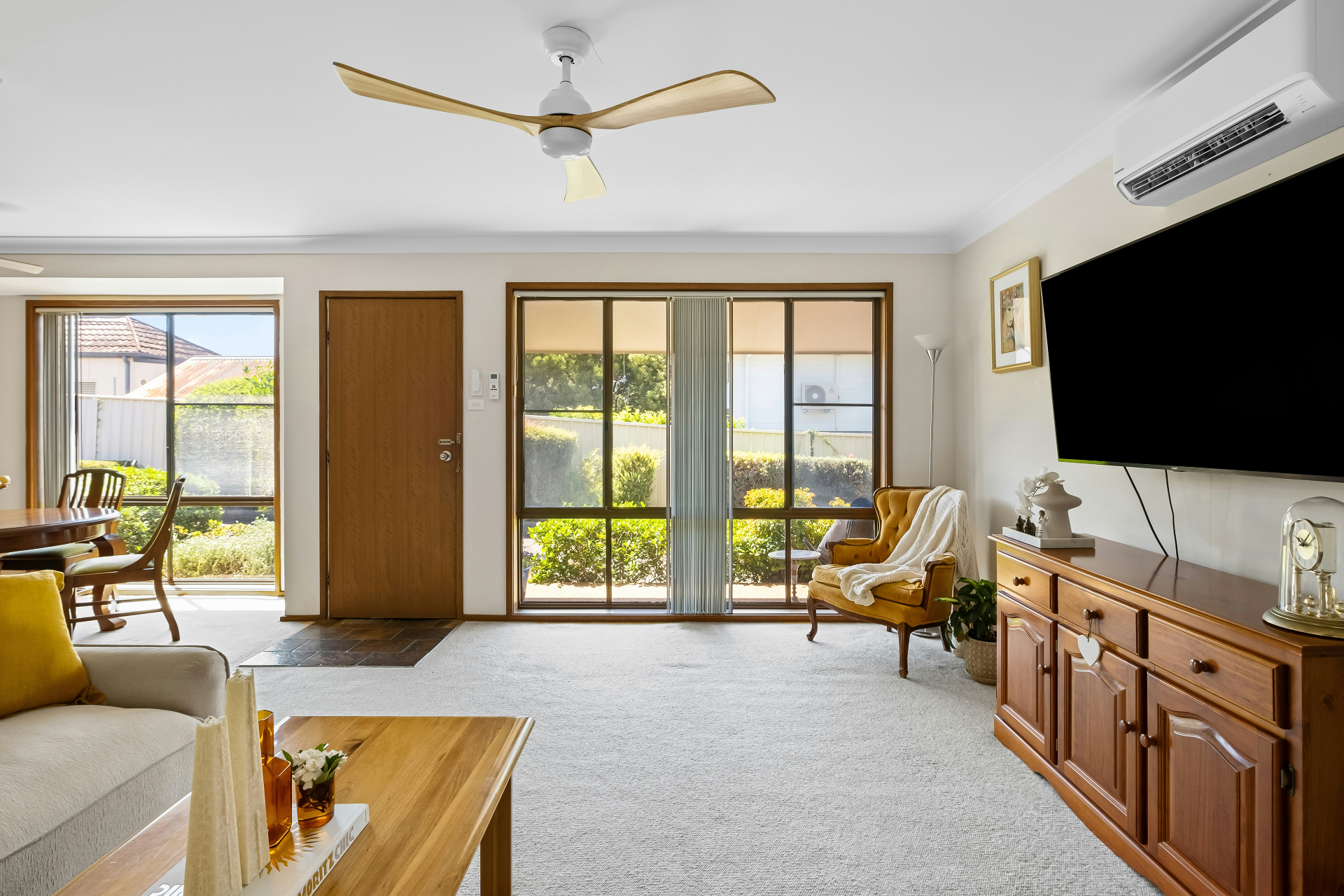 A bright family living room with a ceiling fan, the kind of home a real visit serves